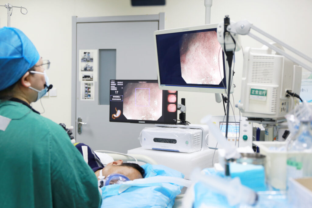 Endoscopist performing AI-assisted colonoscopy with EndoAngel system at hospital